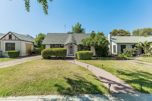 4430 E Iowa Ave, Fresno, CA 93702 - english style home featuring a front yard and a chimney