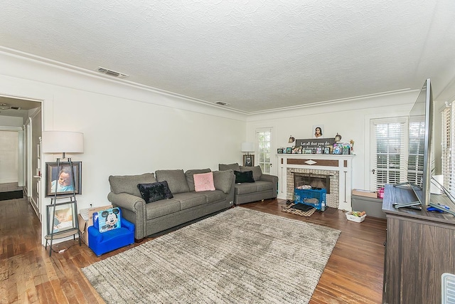 4430 E Iowa Ave, Fresno, CA 93702 - living area featuring wood finished floors, a textured ceiling, a fireplace, and crown molding