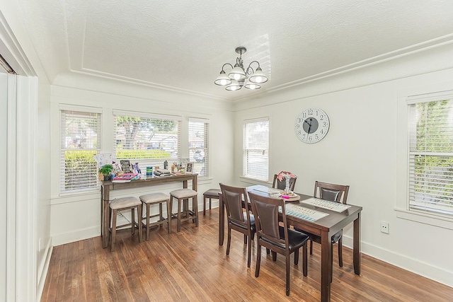 4430 E Iowa Ave, Fresno, CA 93702 - dining space featuring a chandelier, wood finished floors, plenty of natural light, and a textured ceiling