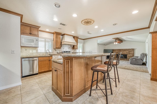 3348 W Sierra Ave, Fresno, CA 93711 - kitchen with dishwasher, white microwave, custom range hood, decorative backsplash, and ornamental molding