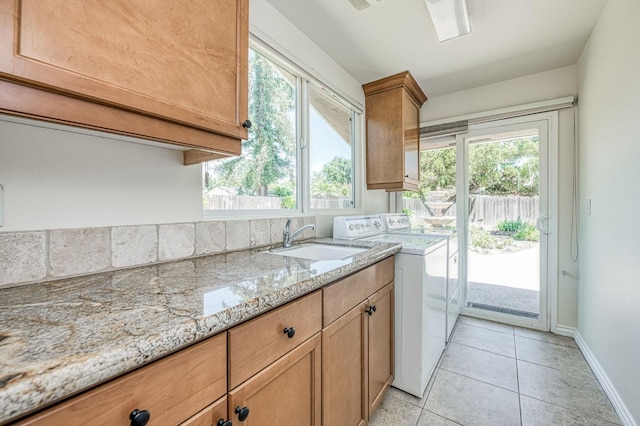 3348 W Sierra Ave, Fresno, CA 93711 - kitchen with independent washer and dryer, light stone counters, and light tile patterned floors