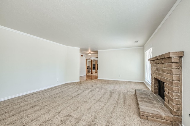 3348 W Sierra Ave, Fresno, CA 93711 - unfurnished living room featuring ornamental molding, a fireplace, carpet, and arched walkways