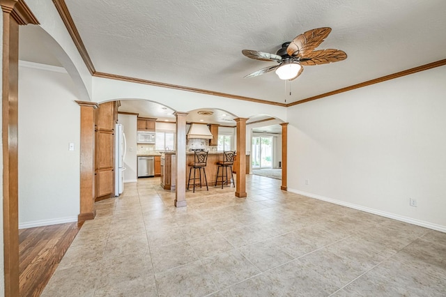 3348 W Sierra Ave, Fresno, CA 93711 - living room with ornate columns, arched walkways, a ceiling fan, crown molding, and a textured ceiling