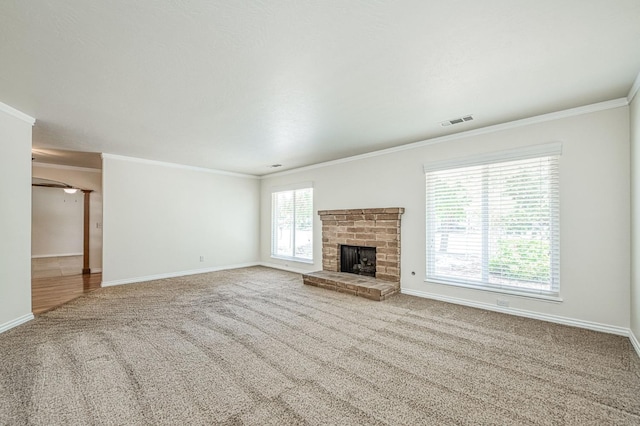 3348 W Sierra Ave, Fresno, CA 93711 - unfurnished living room featuring carpet, crown molding, and a brick fireplace