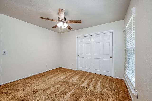 3348 W Sierra Ave, Fresno, CA 93711 - unfurnished bedroom featuring carpet flooring, multiple windows, a closet, and a ceiling fan