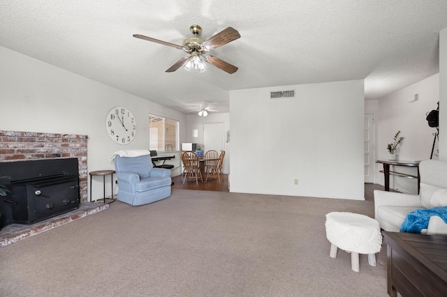 1446 Pico Ave, Clovis, CA 93611 - living area featuring carpet, ceiling fan, a brick fireplace, and a textured ceiling