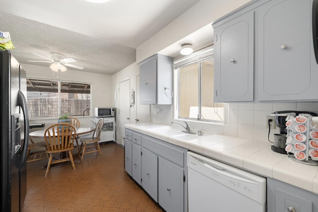 1446 Pico Ave, Clovis, CA 93611 - kitchen with white dishwasher, fridge with ice dispenser, stainless steel microwave, ceiling fan, and decorative backsplash