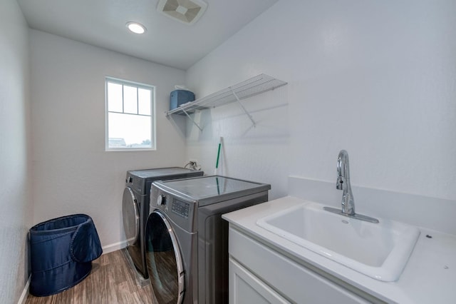 14288 W El Mar Ave, Kerman, CA 93630 - laundry area featuring washer and clothes dryer and wood finished floors