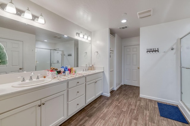 14288 W El Mar Ave, Kerman, CA 93630 - full bathroom featuring a shower stall, double vanity, and wood finished floors