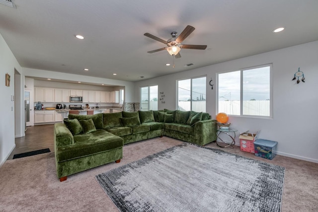 14288 W El Mar Ave, Kerman, CA 93630 - living area with dark colored carpet, ceiling fan, and recessed lighting