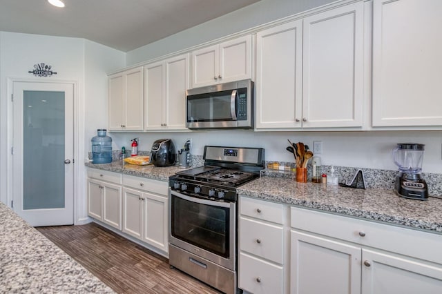 14288 W El Mar Ave, Kerman, CA 93630 - kitchen with appliances with stainless steel finishes, dark wood-style flooring, white cabinets, light stone counters, and recessed lighting