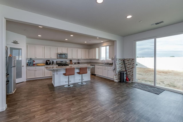 14288 W El Mar Ave, Kerman, CA 93630 - kitchen featuring stainless steel appliances, white cabinets, a kitchen island, recessed lighting, and dark wood-style floors