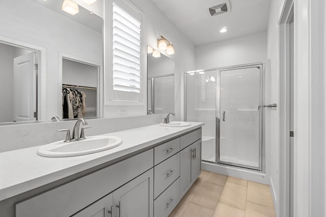 4349 Hillside Rd, Madera, CA 93636 - full bath with double vanity, a stall shower, a spacious closet, and tile patterned floors