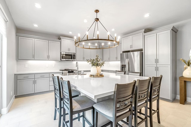 4349 Hillside Rd, Madera, CA 93636 - kitchen with appliances with stainless steel finishes, gray cabinetry, a chandelier, recessed lighting, and light countertops