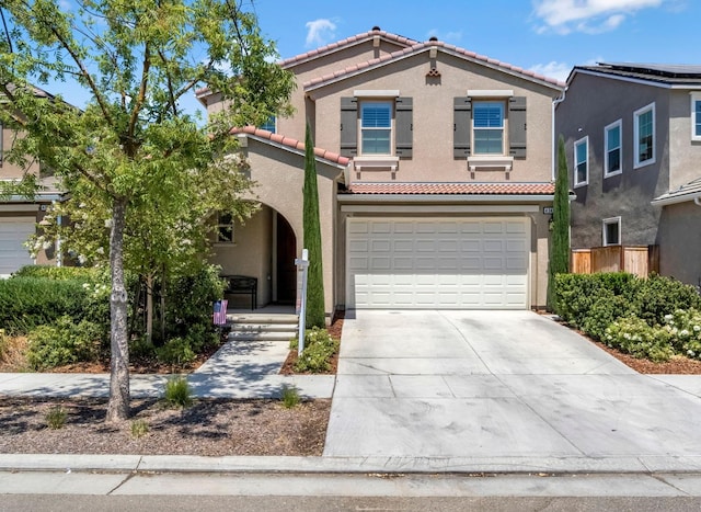 4349 Hillside Rd, Madera, CA 93636 - mediterranean / spanish-style house featuring a tiled roof, concrete driveway, an attached garage, and stucco siding