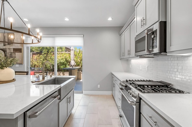 4349 Hillside Rd, Madera, CA 93636 - kitchen with appliances with stainless steel finishes, tasteful backsplash, light countertops, a chandelier, and recessed lighting