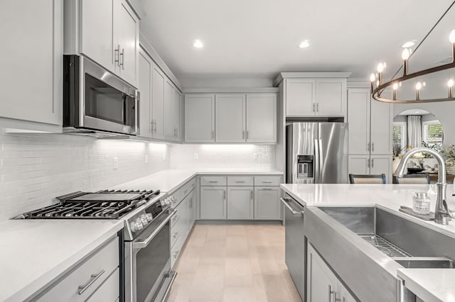 4349 Hillside Rd, Madera, CA 93636 - kitchen featuring stainless steel appliances, decorative backsplash, light countertops, recessed lighting, and decorative light fixtures