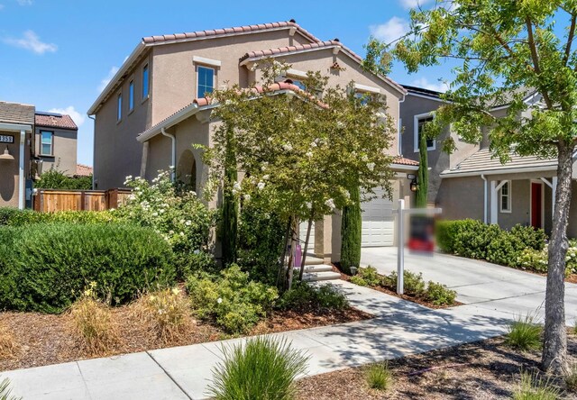 4349 Hillside Rd, Madera, CA 93636 - view of front of property featuring stucco siding, driveway, a tile roof, and an attached garage