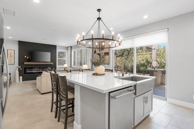 4349 Hillside Rd, Madera, CA 93636 - kitchen featuring stainless steel dishwasher, an island with sink, a chandelier, healthy amount of natural light, and recessed lighting
