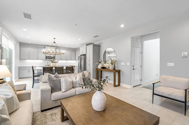 4349 Hillside Rd, Madera, CA 93636 - living room with a chandelier, arched walkways, recessed lighting, and light tile patterned floors