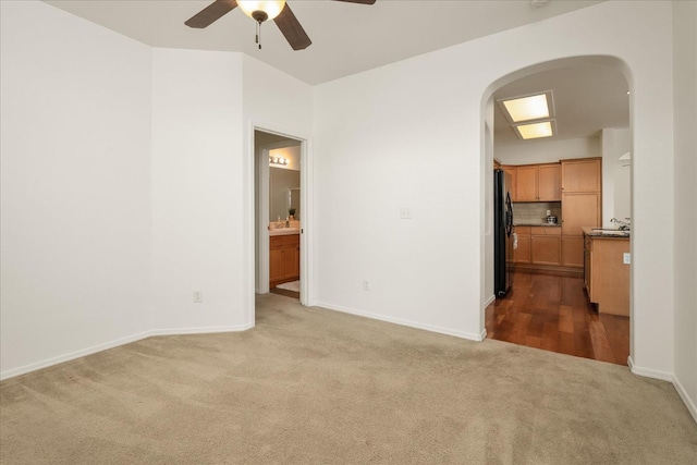 1935 N Glen Alva Ln, Clovis, CA 93619 - spare room with arched walkways, carpet flooring, and a ceiling fan