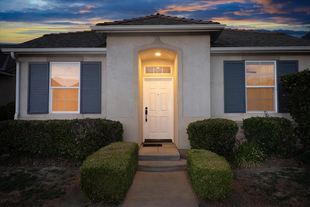 1935 N Glen Alva Ln, Clovis, CA 93619 - exterior entry at dusk featuring stucco siding and a shingled roof