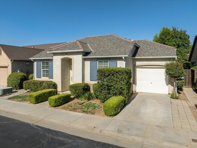 1935 N Glen Alva Ln, Clovis, CA 93619 - view of front of house with a garage, stucco siding, driveway, and a shingled roof