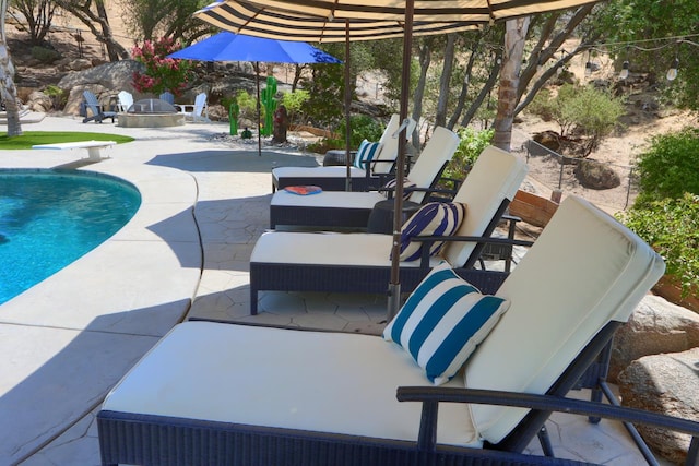 43295 Running Deer Dr, Coarsegold, CA 93614 - outdoor pool featuring a patio, a diving board, and an outdoor living space with a fire pit