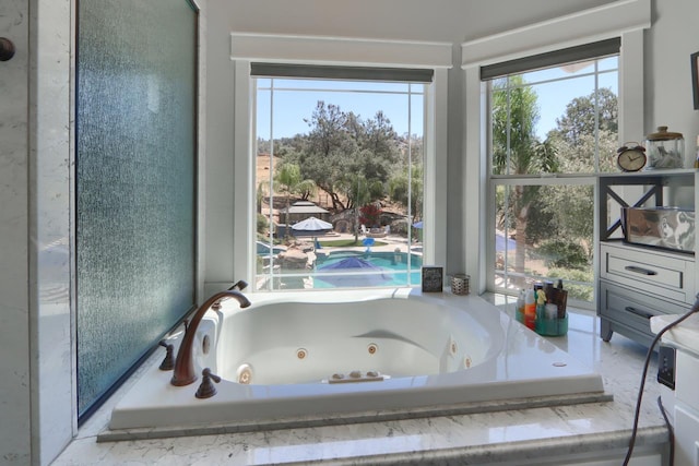43295 Running Deer Dr, Coarsegold, CA 93614 - bathroom featuring healthy amount of natural light and a tub with jets