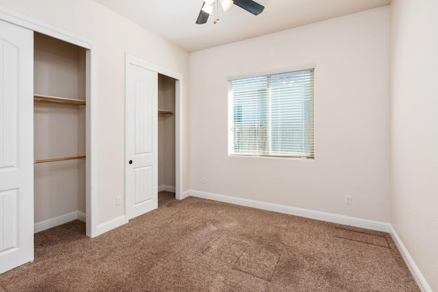 7399 N Riverside Dr, Fresno, CA 93722 - unfurnished bedroom with carpet flooring, two closets, and ceiling fan