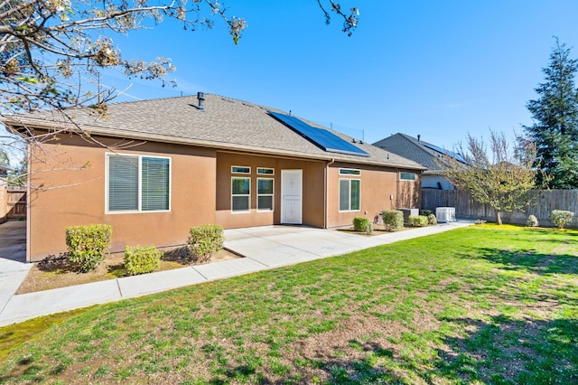 7399 N Riverside Dr, Fresno, CA 93722 - rear view of property featuring stucco siding, a fenced backyard, solar panels, and a patio area