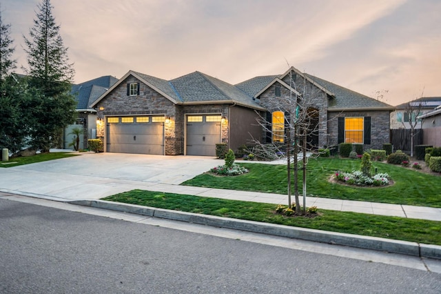 7399 N Riverside Dr, Fresno, CA 93722 - view of front of home with stone siding, an attached garage, a front lawn, and driveway