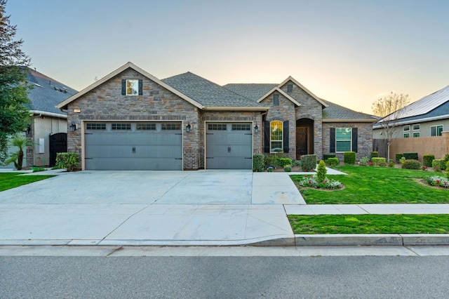7399 N Riverside Dr, Fresno, CA 93722 - view of front of property featuring a garage, driveway, stone siding, and roof with shingles