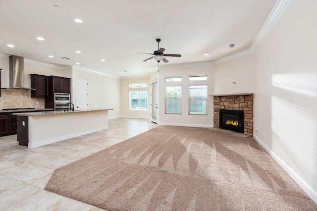 7399 N Riverside Dr, Fresno, CA 93722 - unfurnished living room featuring a ceiling fan, crown molding, recessed lighting, a fireplace, and light tile patterned floors