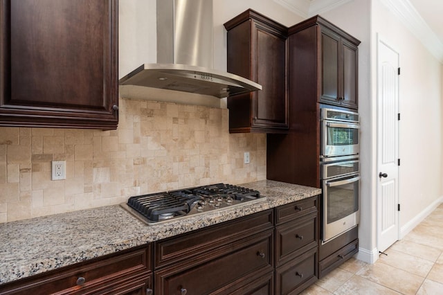 7399 N Riverside Dr, Fresno, CA 93722 - kitchen featuring wall chimney exhaust hood, stainless steel gas cooktop, crown molding, light stone countertops, and dark brown cabinets
