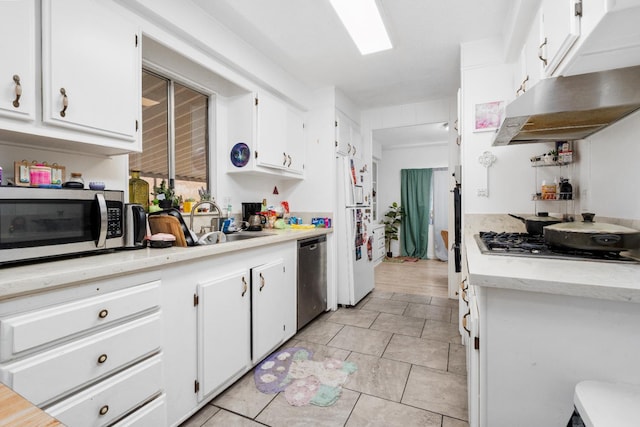 2575 S Willow Ave Unit 229, Fresno, CA 93725 - kitchen with stainless steel appliances, white cabinetry, under cabinet range hood, and light tile patterned flooring