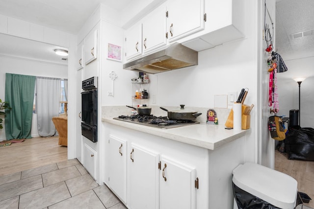 2575 S Willow Ave Unit 229, Fresno, CA 93725 - kitchen with under cabinet range hood, stainless steel gas cooktop, a warming drawer, light countertops, and oven