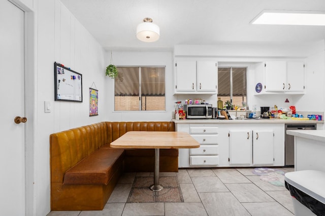2575 S Willow Ave Unit 229, Fresno, CA 93725 - kitchen featuring breakfast area, appliances with stainless steel finishes, light countertops, and white cabinets