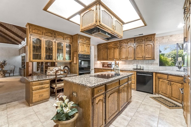 1917 Evergreen Pl, Madera, CA 93637 - kitchen featuring black appliances, light tile patterned flooring, backsplash, light stone counters, and brown cabinets