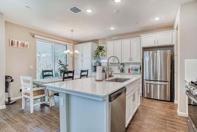 212 Arbor Dr S, Madera, CA 93636 - kitchen with appliances with stainless steel finishes, light wood-style floors, white cabinetry, and recessed lighting