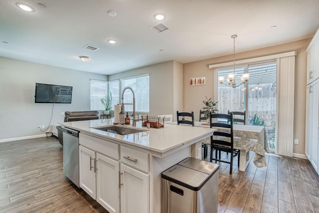 212 Arbor Dr S, Madera, CA 93636 - kitchen with stainless steel dishwasher, a chandelier, wood finished floors, plenty of natural light, and recessed lighting