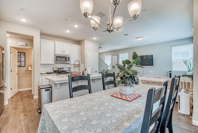 212 Arbor Dr S, Madera, CA 93636 - dining area featuring light wood-style floors, recessed lighting, and a chandelier