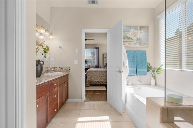 3982 Flint Ave, Clovis, CA 93619 - bathroom with vanity, connected bathroom, a bath, tile patterned floors, and ceiling fan