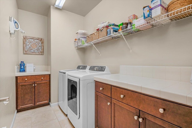 3982 Flint Ave, Clovis, CA 93619 - laundry area with washer and dryer, light tile patterned floors, and cabinet space