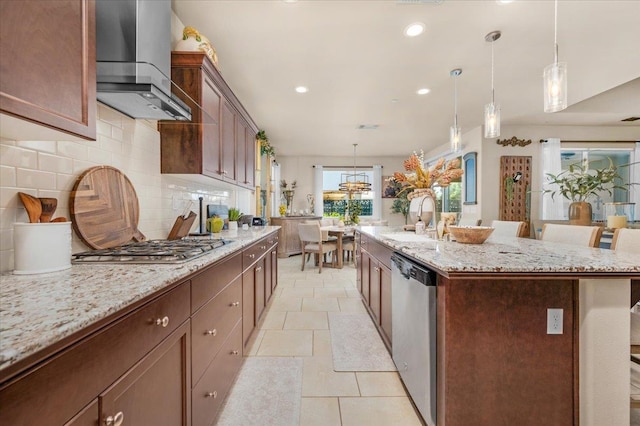 3982 Flint Ave, Clovis, CA 93619 - kitchen with wall chimney range hood, stainless steel appliances, recessed lighting, backsplash, and a kitchen island with sink