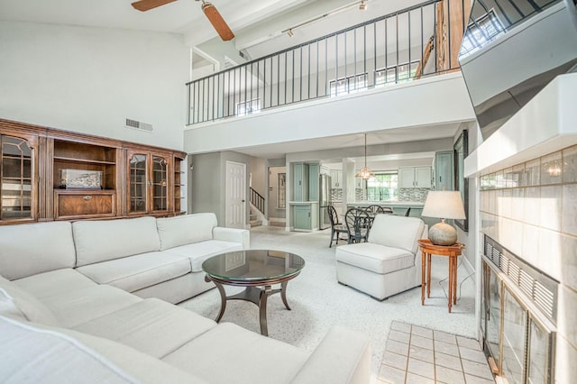 7047 N Teilman Ave Unit 102, Fresno, CA 93711 - living area featuring high vaulted ceiling, a ceiling fan, and stairway