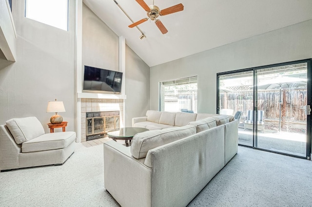 7047 N Teilman Ave Unit 102, Fresno, CA 93711 - living room with high vaulted ceiling, carpet flooring, a ceiling fan, and a tiled fireplace
