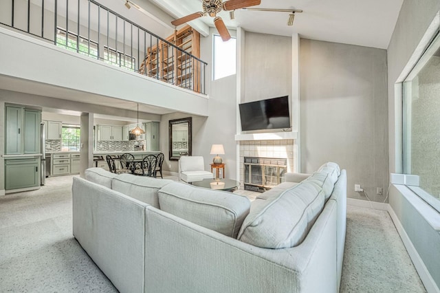 7047 N Teilman Ave Unit 102, Fresno, CA 93711 - living area featuring ceiling fan, high vaulted ceiling, a fireplace, and light carpet