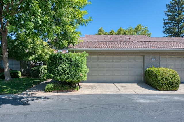 7047 N Teilman Ave Unit 102, Fresno, CA 93711 - view of front of house featuring a tiled roof and concrete driveway