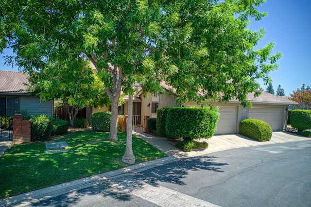 7047 N Teilman Ave Unit 102, Fresno, CA 93711 - obstructed view of property with driveway, a garage, and a tile roof